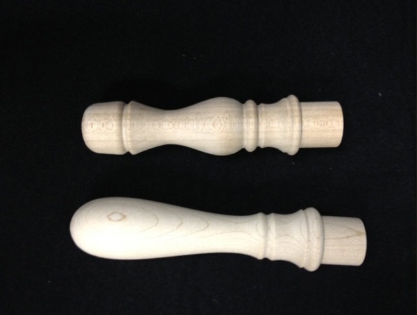 Two unfinished turned wooden brush handles, customizable for various applications.